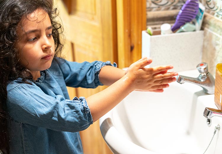Criança lavando as mãos